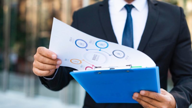 front-view-business-man-looking-charts-scaled.jpg